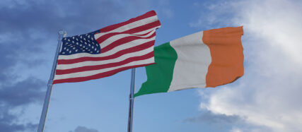 U.S. and Irish flags waving in the sky